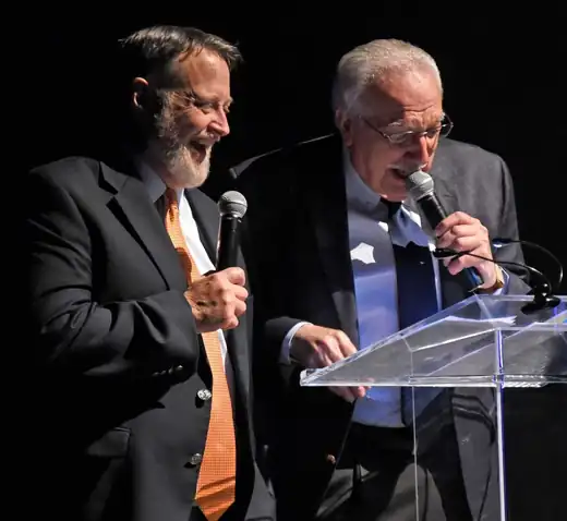 Chris Doelle at the podium with Brother Gary Moses